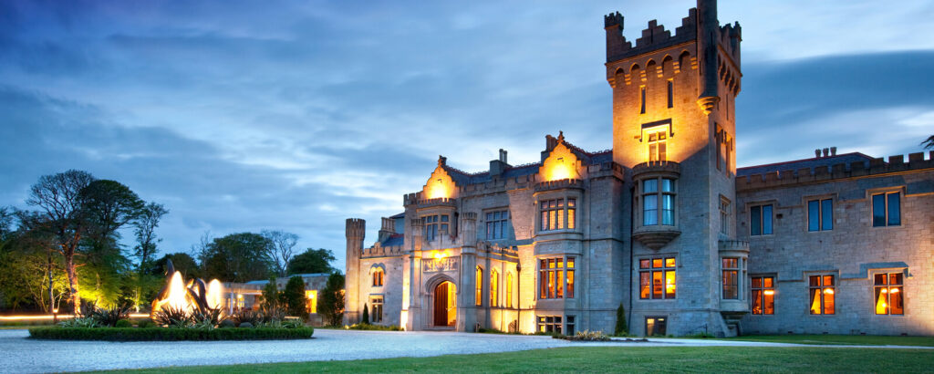 photo of Lough Eske Castle in twilight with lights on