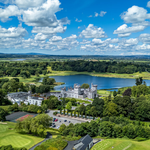 Dromoland Castle showing the castle and water as well as the grounds