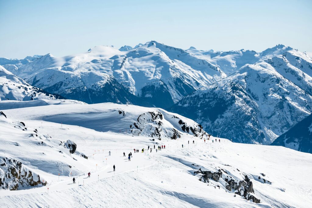 Whistler Blackcomb photo showing people skiing in the mountains