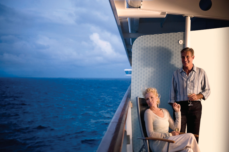 Couple on their cabin balcony of their small ship cruise